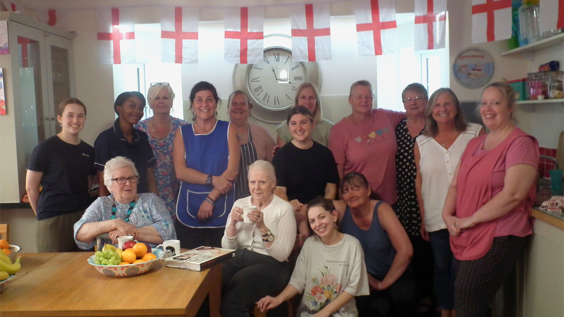 care-staff-group-photo Group photo of some of the St Andrew's Care Home staff posing in the kitchen with two of the care home residents